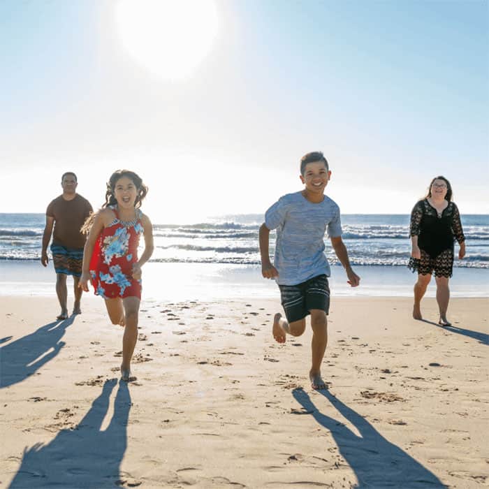 Home-family-on-beach-running-700SQ